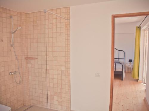 a bathroom with a shower with a glass door at Gartenappartement - Tierra - Surf & Yoga Villa in La Pared