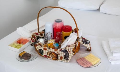 a bag filled with food and other items on a table at Urbano Suítes in Ubatuba