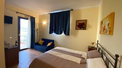 a bedroom with a bed and a blue couch at CasaFè tra sogno e realtà in Narni Scalo