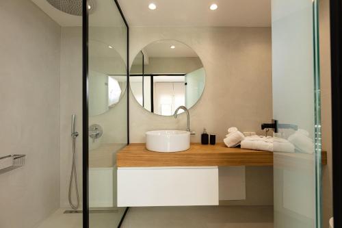 a bathroom with a sink and a mirror at TheTree Villa, with Heated Pool & Spa Whirlpool in Gállos