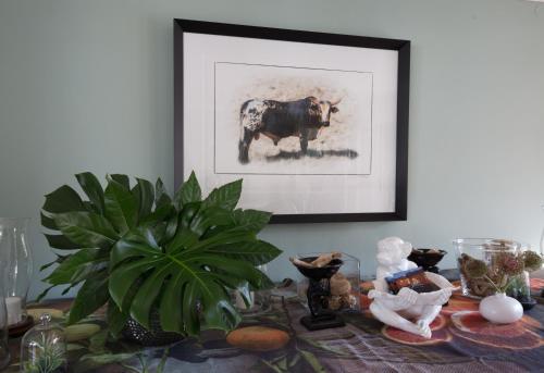 a table with a picture of a cow on it at Parkwood Boutique Hotel in Johannesburg
