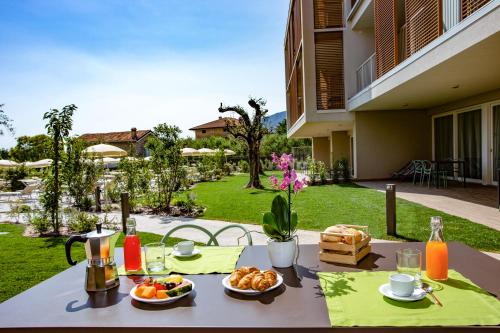 a table with plates of food on top at Residenza Olivo in Garda