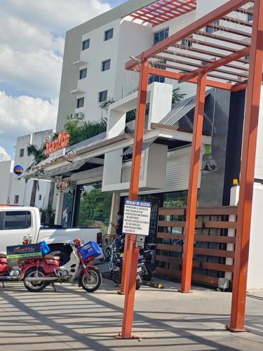 a group of motorcycles parked in front of a building at Torre Real IV L3 Santiago DR con cocinero para desayuno in Santiago de los Caballeros