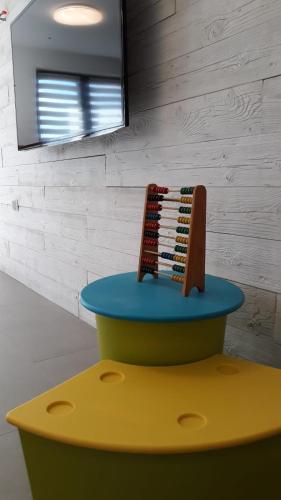 a colorful stool with a comb on top of it at Dom z basenem i widokiem na łąkę in Raduń