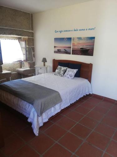 a bedroom with a bed and a picture on the wall at Retiro do Mestre in Mondim de Basto