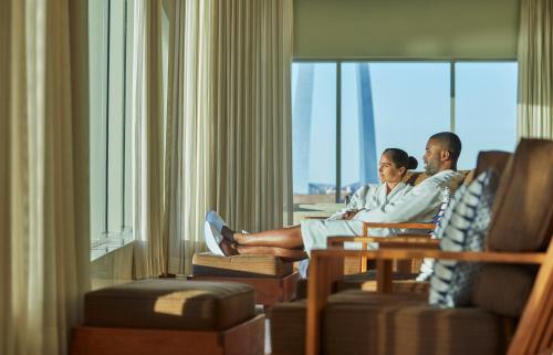 two men sitting in a hotel room looking out the window at Four Seasons St. Louis in Saint Louis