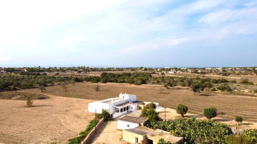 an aerial view of a white house in a field at Can Marianet in San Ferrán de ses Roques