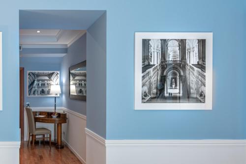 a room with a table and a picture of a building at Palazzo Turchini in Naples