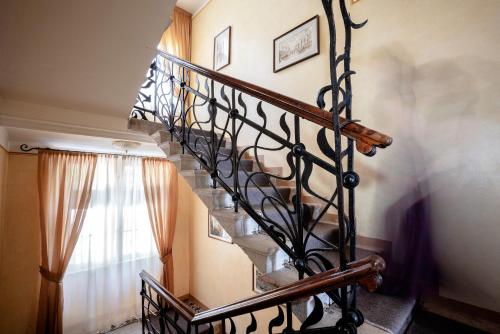 a spiral staircase in a home with a window at Hotel Bellevue in Gardone Riviera