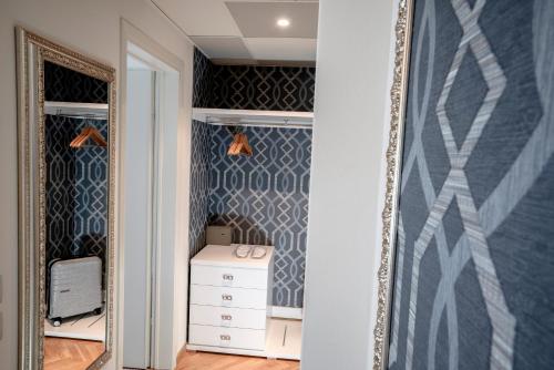 a dressing room with a mirror and a dresser at Hotel Bellevue in Gardone Riviera