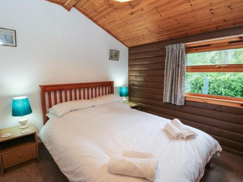En eller flere senge i et værelse på Millmore Cabin