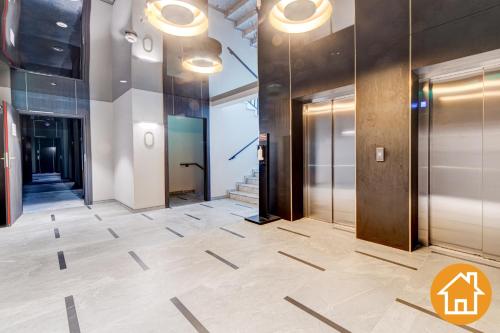 a hallway with elevators in a building at Apartamenty ApartPark - visitopl in Świnoujście