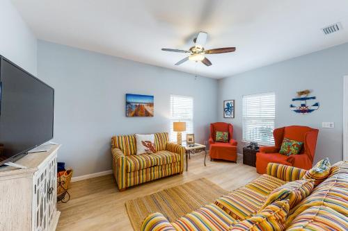 a living room with couches and a flat screen tv at Knot a Care in Mexico Beach