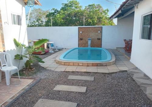 a swimming pool in the backyard of a house at AYRE GOSTOSO POUSADA in São Miguel do Gostoso