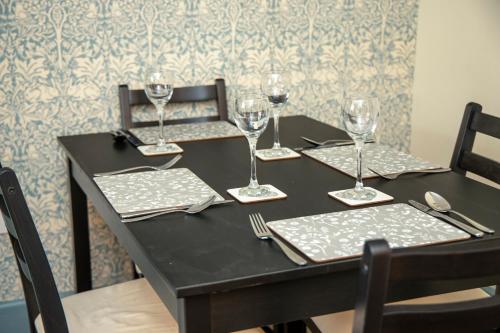 a black table with wine glasses on top of it at The Burrow in Chideock
