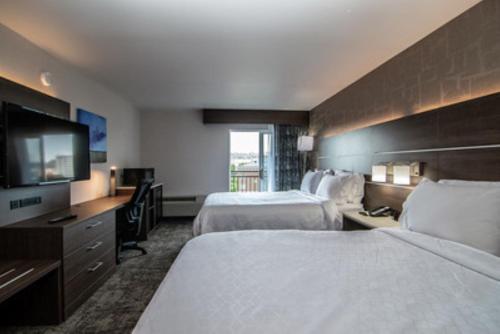 a hotel room with two beds and a flat screen tv at Holiday Inn Express Spokane-Downtown by IHG in Spokane