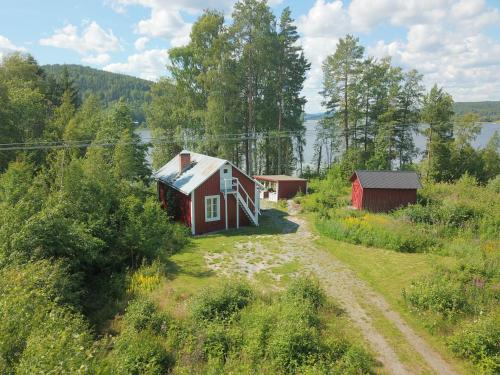 an aerial view of a farm with a barn and a road at Fjordhouse Donar in Bjärtrå