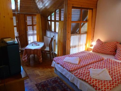 a bedroom with a bed and a table in a room at Oleander B&B in Siófok