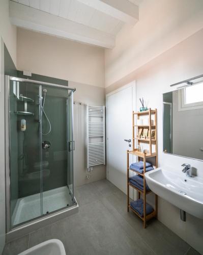 a bathroom with a glass shower and a sink at A casa di Sabina in Desenzano del Garda