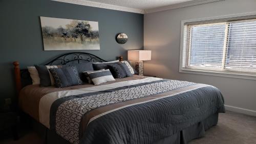 a bedroom with a large bed with blue walls at Gatlinburg Chateau Condo 309 in Gatlinburg