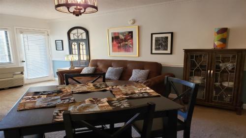 a living room with a table and a couch at Gatlinburg Chateau Condo 309 in Gatlinburg