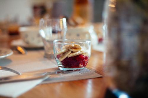 a glass with fruit and nuts in it on a table at les Didascalies in Vic-Fezensac