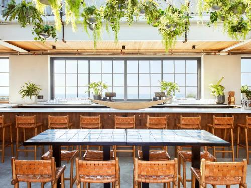 a dining room with a table and chairs at The Rockaway Hotel in Queens