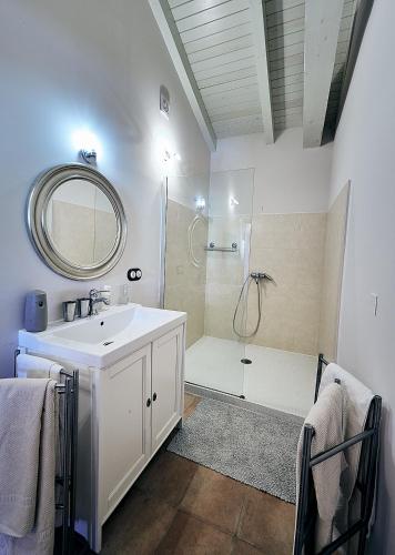 a bathroom with a sink and a shower with a mirror at Pazo de Lemaio in Laracha