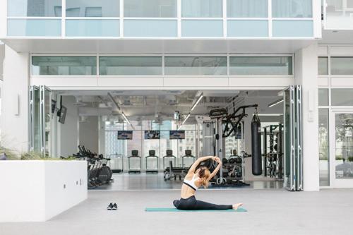 a woman doing a yoga pose in a gym at Level Los Angeles - Downtown South Olive in Los Angeles