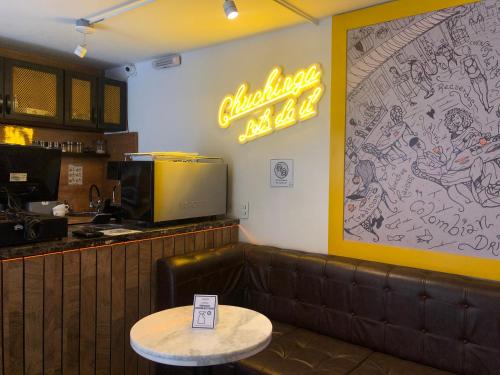 a restaurant with a table and a sign on the wall at Villaviciosa Hotel Boutique in Pasto