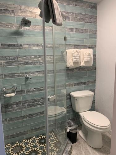 a bathroom with a toilet and a glass shower at Oak Creek Terrace Resort in Sedona