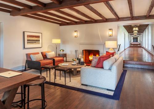 a living room with a couch and a fireplace at Ojai Valley Inn in Ojai