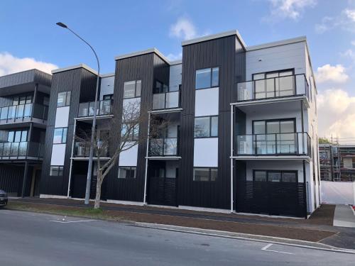 an apartment building with black and white at Central Stadium Apartments in Hamilton