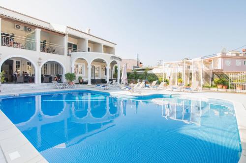 a large swimming pool in front of a building at OPERA BLUE Hotel Gouvia Corfu in Gouvia