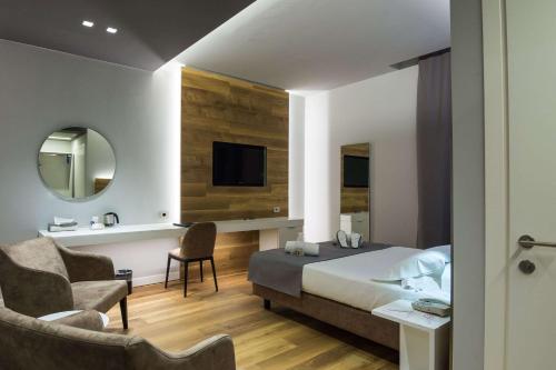 a bedroom with a bed and a chair and a mirror at Best Western Hotel Turismo in San Martino Buon Albergo