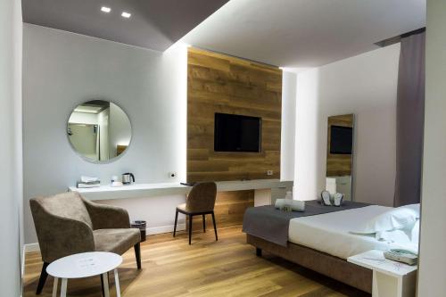 a bedroom with a bed and a tv and a chair at Best Western Hotel Turismo in San Martino Buon Albergo