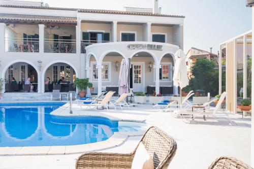 a hotel with a swimming pool in front of a building at OPERA BLUE Hotel Gouvia Corfu in Gouvia