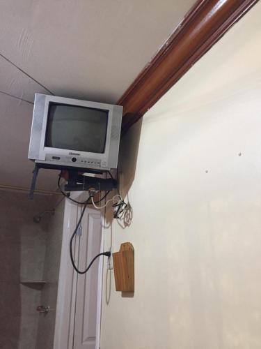 a television sitting on a shelf in a room at Hotel Fika Guayaquil in Guayaquil