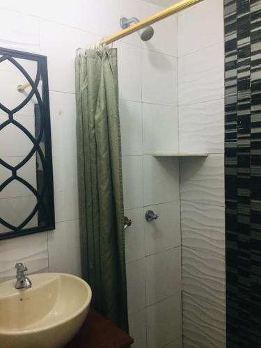 a bathroom with a shower and a sink at Hotel Fika Guayaquil in Guayaquil