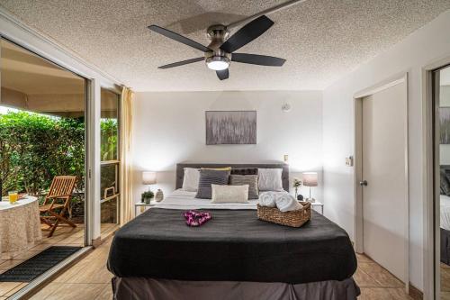 a bedroom with a bed and a ceiling fan at 1 BD King Suite: 40% OFF, Beach Walk in Wailea