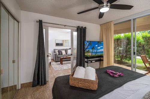 a bedroom with a bed and a living room at 1 BD King Suite: 40% OFF, Beach Walk in Wailea