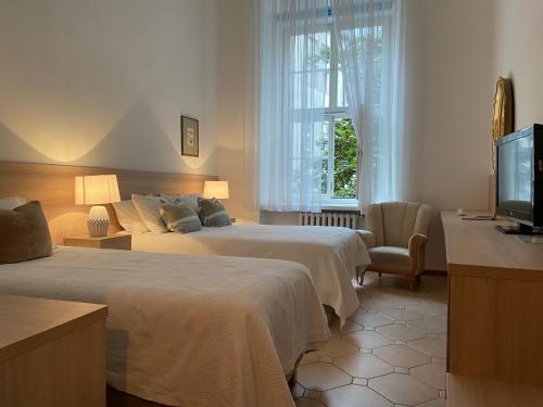 Un pat sau paturi într-o cameră la Boutique Aparthotel