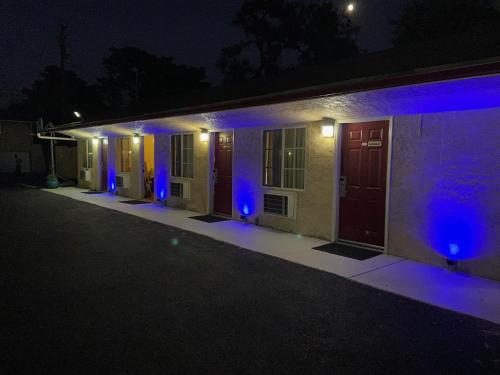 a row of houses lit up at night with blue lights at Economy Inn Paso Robles in Paso Robles
