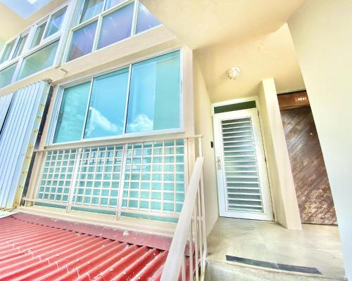 a house with a large window and a red roof at KASA El Sol by the Sea with Pool and Parking in San Juan
