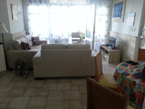 a living room with a couch and a table at Los Balcones in Sosúa