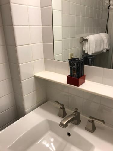 a bathroom with a sink and a mirror at Touchstone Hotel - City Center in San Francisco