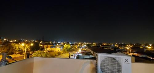 a view of a city at night with lights at NCG SUITE SAMANES in Guayaquil