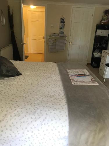 a bedroom with a bed with a comforter on it at Luxury 3 bedded room with sea peeps and parking in Paignton