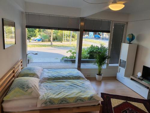 a bedroom with two beds and a large window at Apartments ChezTom Nenzing in Nenzing