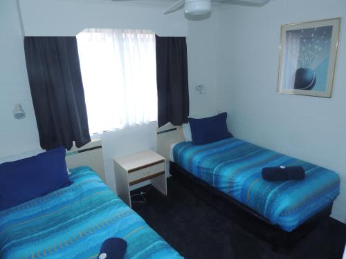 Tempat tidur dalam kamar di Argyle Terrace Motor Inn